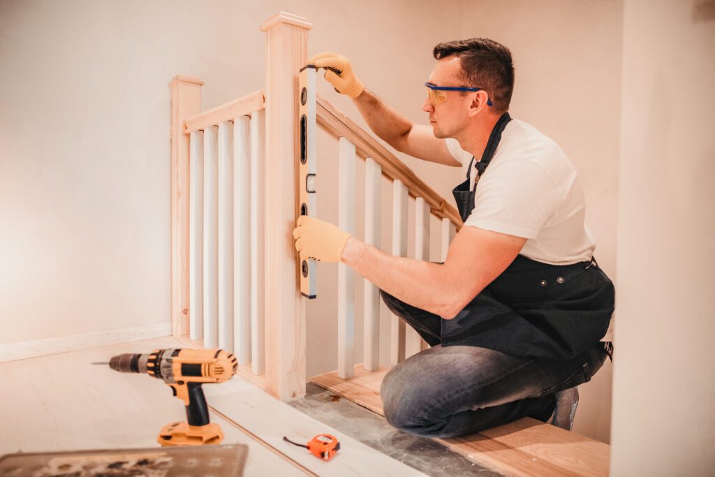 man installing stair railings